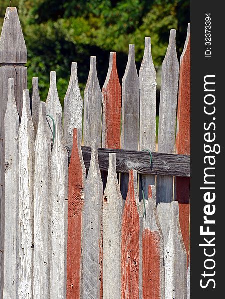 Old weathered wooden picket fence. Old weathered wooden picket fence