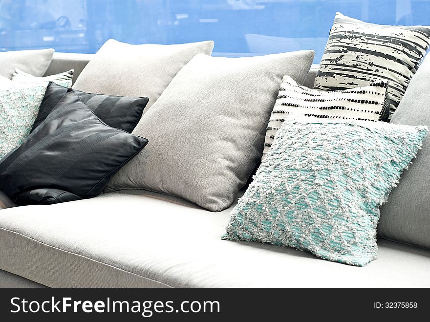 Various size and clor of cushion pillows on sofa