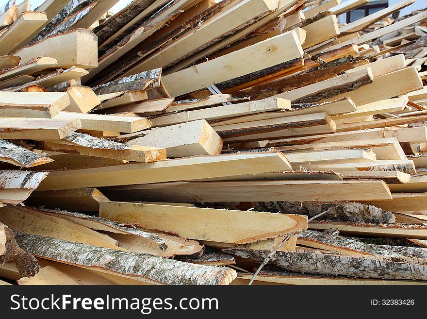 Various wood firewood stacked in a pile. Various wood firewood stacked in a pile