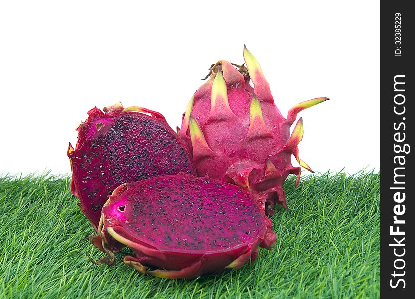 Vivid Dragon fruit isolated on a green grass