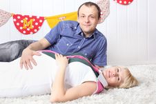 Happy Pregnant Wife And Husband Lie On Carpet Stock Photos Happy Pregnant Wife And Husband Lie On Carpet Stock Photos