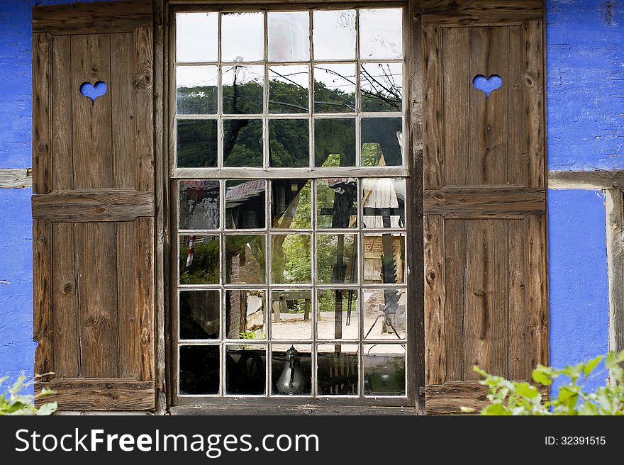 Beautiful old window with shutters with hearts