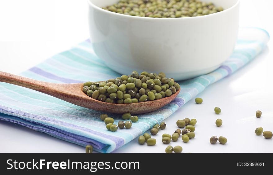 Mung beans over wooden spoon