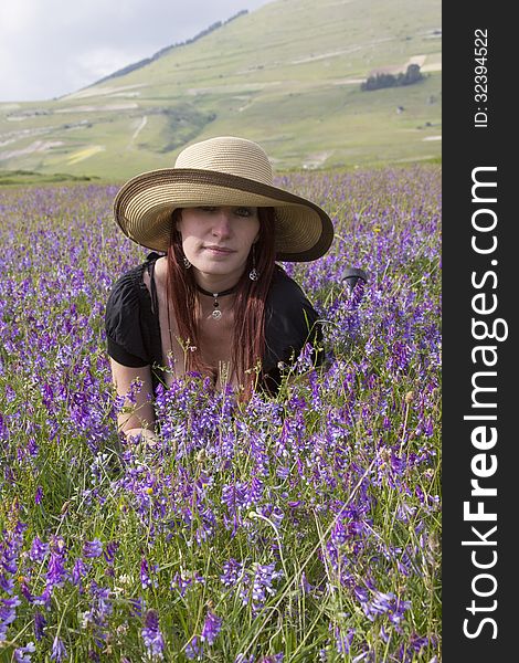 Portrait of fashion woman on violet flowers. Portrait of fashion woman on violet flowers.