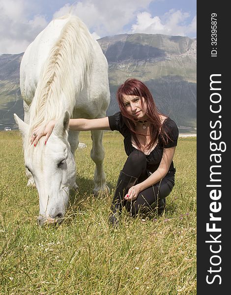 Woman with white horse on field