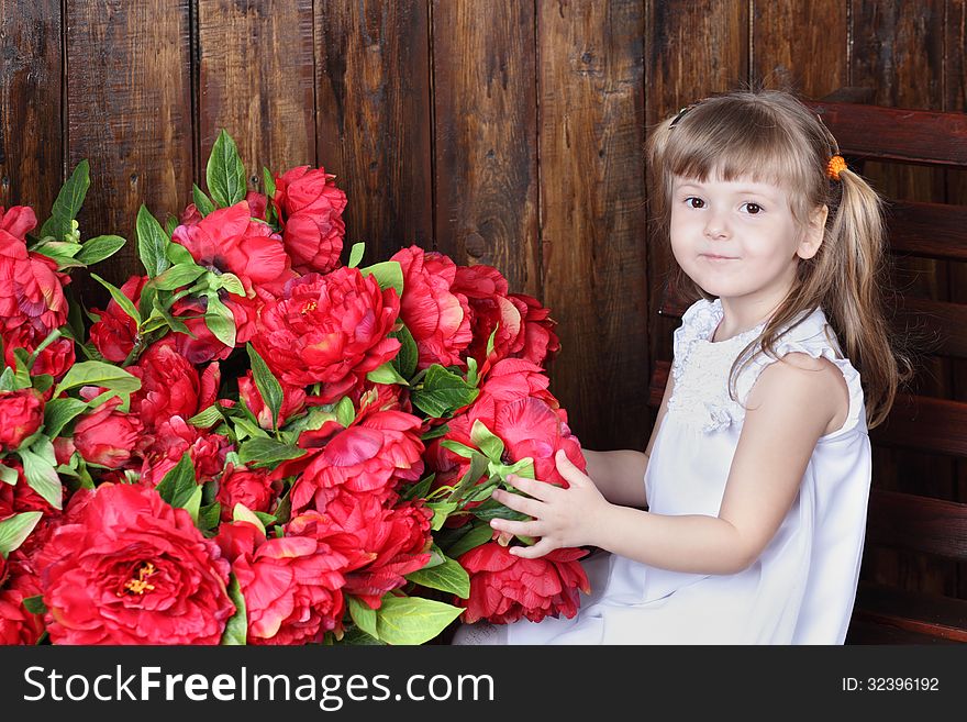 Little Beautiful Girl In White Dress And Large Bouquet