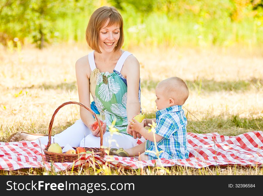 Mom and son have a picnic. This image has attached release.