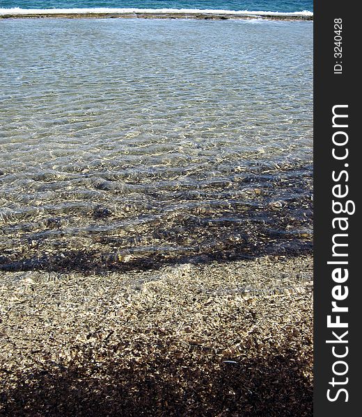 A close view of seashore and reflections on the water. A close view of seashore and reflections on the water