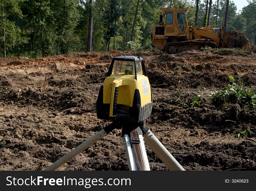 Construction setting transit level on home construction site basement. Construction setting transit level on home construction site basement