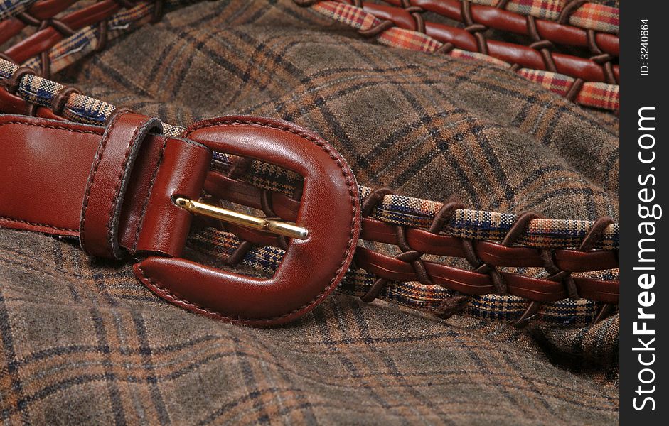 Leather belt over a wool textile fabric, fashion. Leather belt over a wool textile fabric, fashion