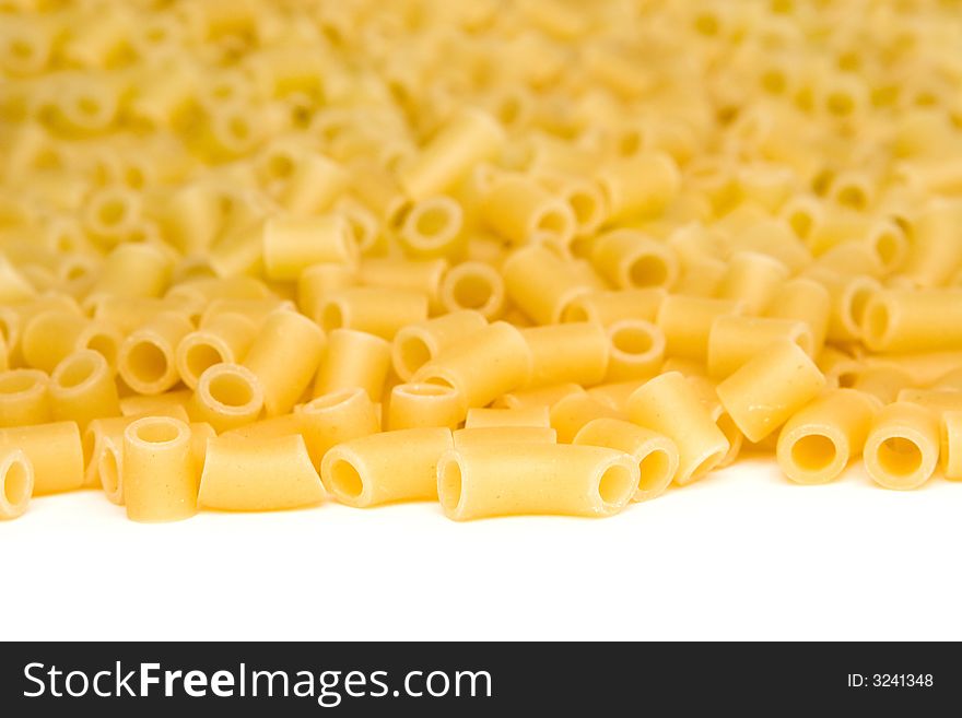 Close up of uncooked macaroni isolated on a white background