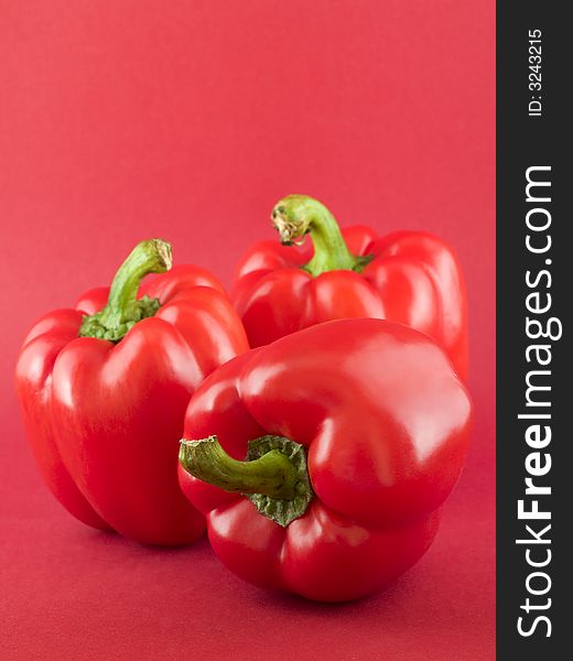 Still of red large beefy red peppers on red background. Still of red large beefy red peppers on red background