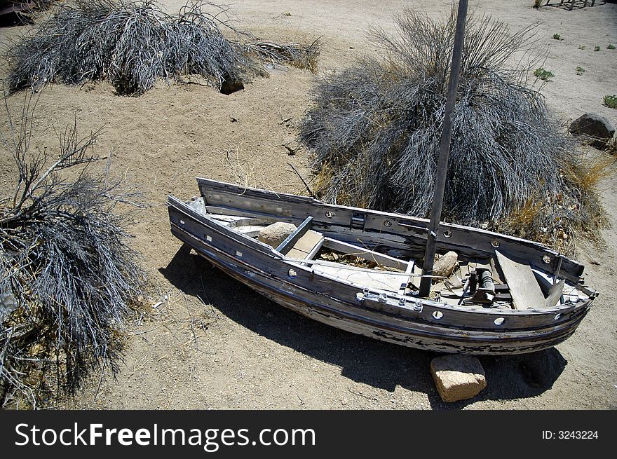 An abandoned old wooden toy boat found in the desert. An abandoned old wooden toy boat found in the desert.