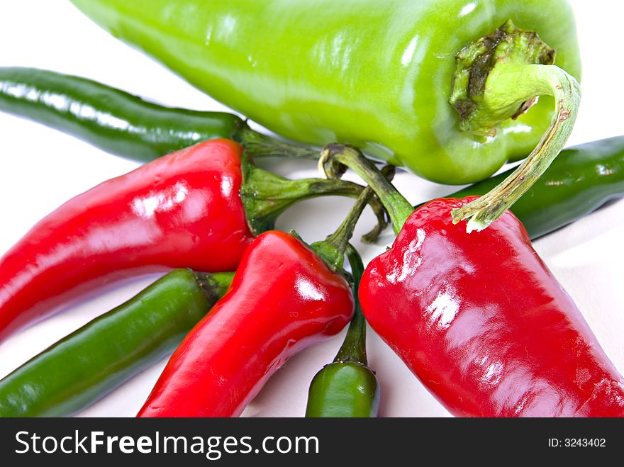 Horizontal color view of anaheim, red jalapeno and green serrano hot peppers. Horizontal color view of anaheim, red jalapeno and green serrano hot peppers