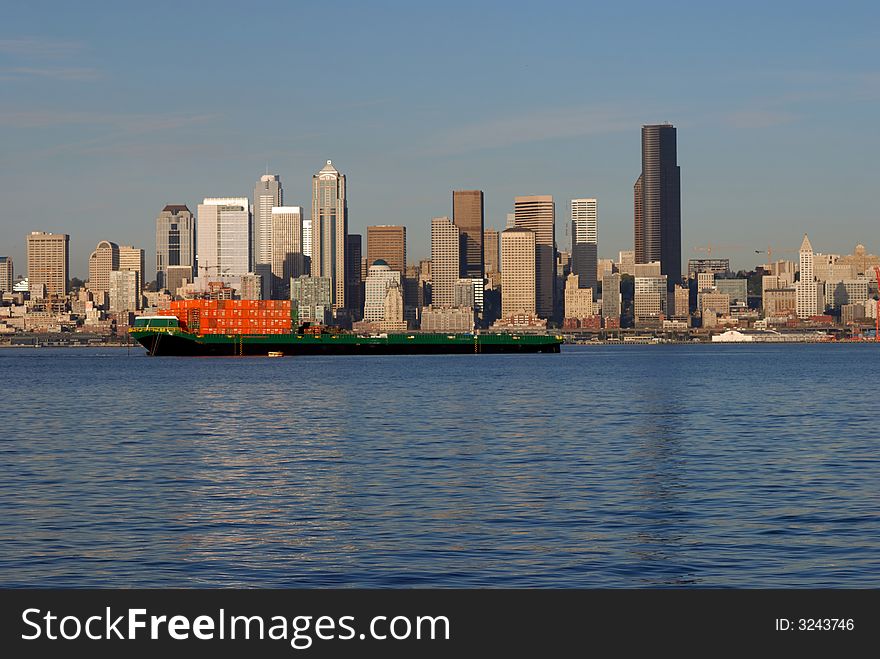 A ship is passing by the downtown Seattle Skyline. A ship is passing by the downtown Seattle Skyline