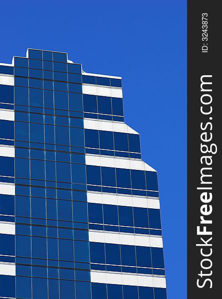 Blue corporate building against a blue sky. Blue corporate building against a blue sky