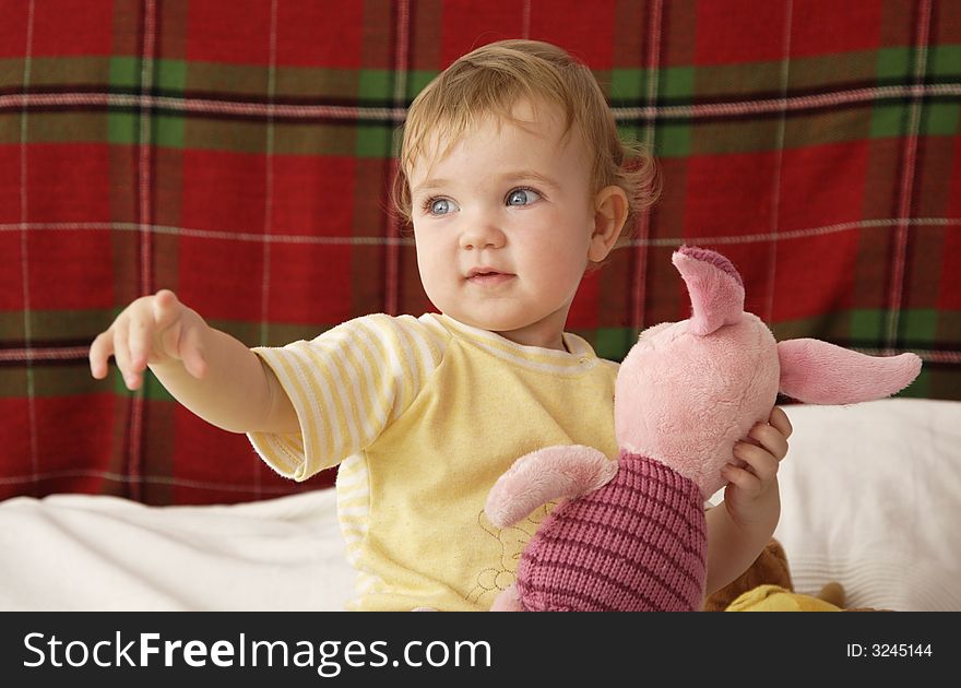 A baby is playing on a bed. A baby is playing on a bed.