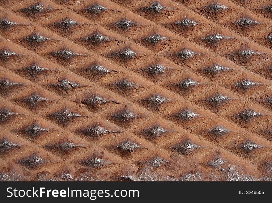 Close up of a diamond shaped metal rusty background. Close up of a diamond shaped metal rusty background