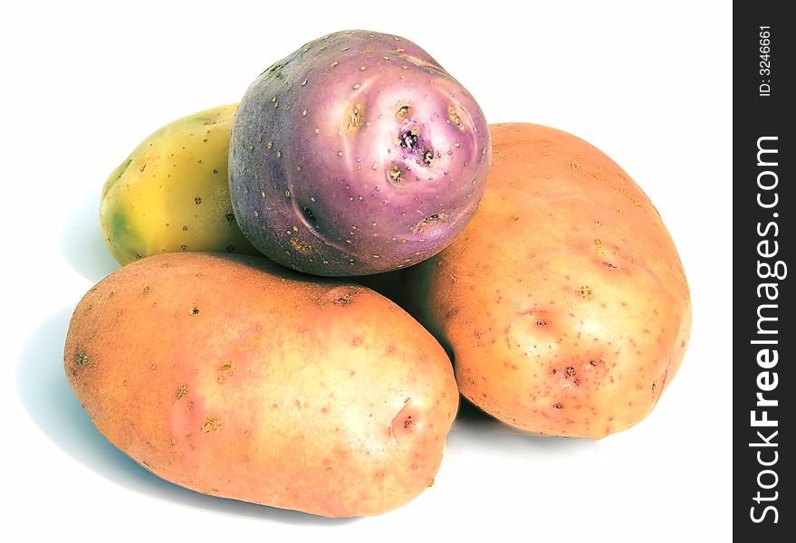 A multi-coloured potato, tasty and useful vegetables, on a white background. A multi-coloured potato, tasty and useful vegetables, on a white background.