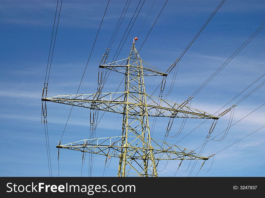 Electrical power lines, isolators and mast in blue cloudy sky, horizontal. Electrical power lines, isolators and mast in blue cloudy sky, horizontal.