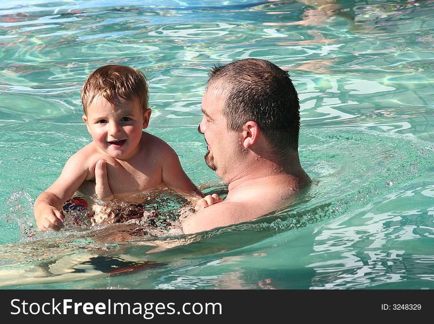 Father and son in the water at the pool