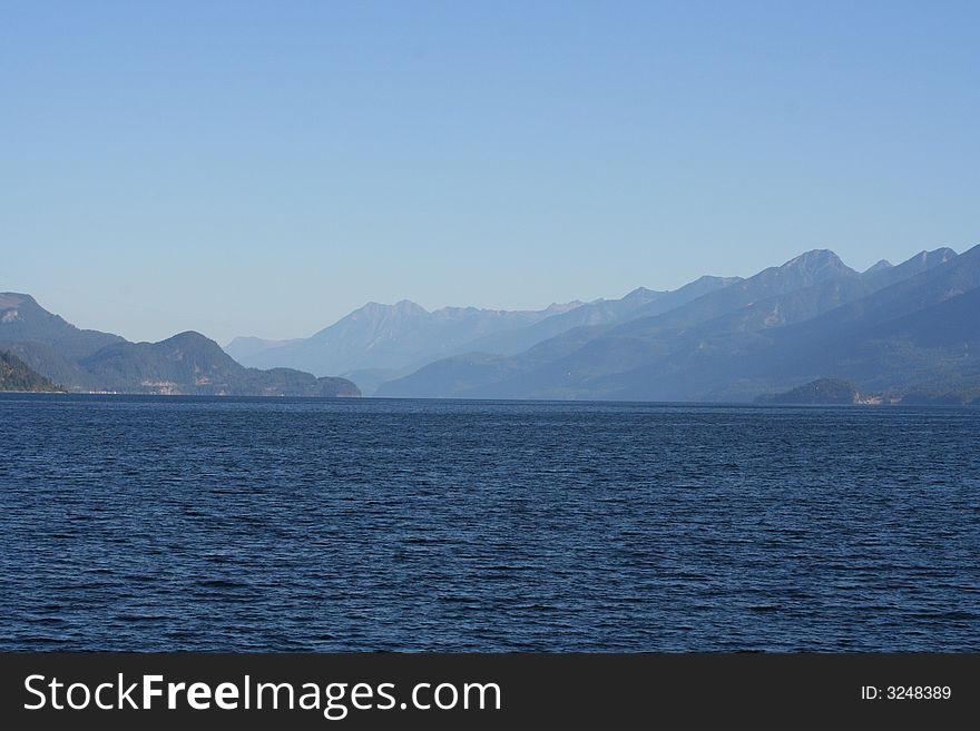 Blue water and mountains lanes in the back