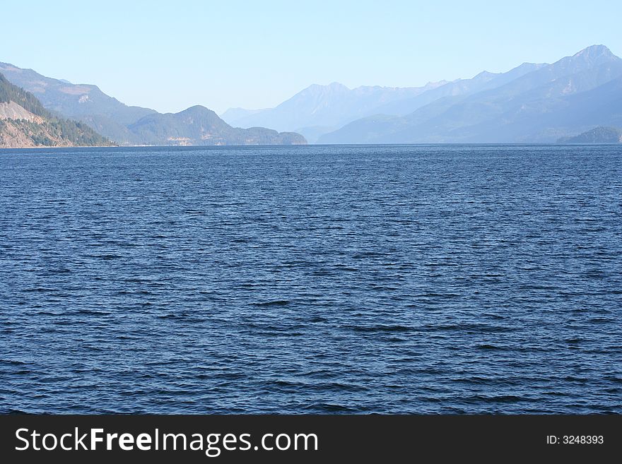 Blue water and mountains lanes in the back