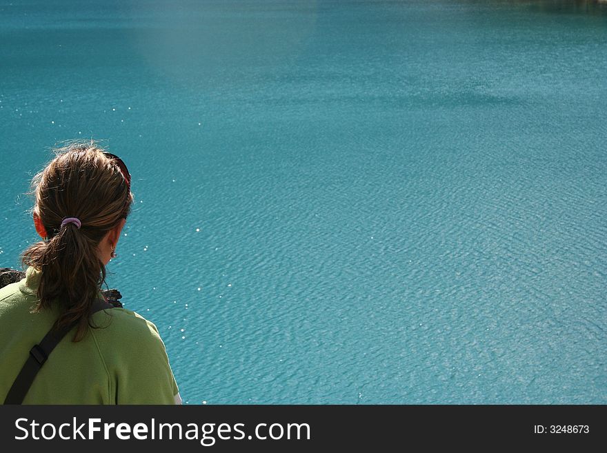 Girl Overlooking A Blue Lake