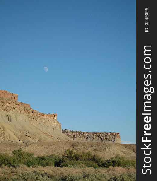 This late afternoon shot captured the moon rising over a Colorado Mesa. This late afternoon shot captured the moon rising over a Colorado Mesa