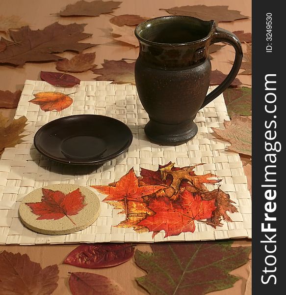Still life â€“ the  tea-cloth ornamented with leaves - decoupage. Still life â€“ the  tea-cloth ornamented with leaves - decoupage