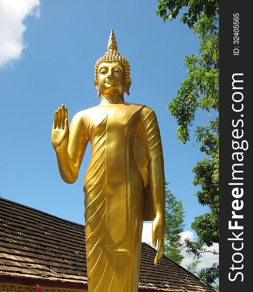 Golden buddha statue stand at temple