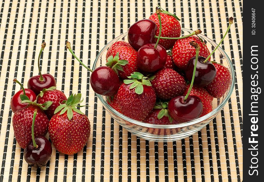 Strawberry And Sweet Cherry In A Glass Vase