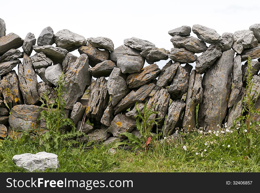 Rocks forming a stonewall between fields in Ireland. County Claire. Rocks forming a stonewall between fields in Ireland. County Claire
