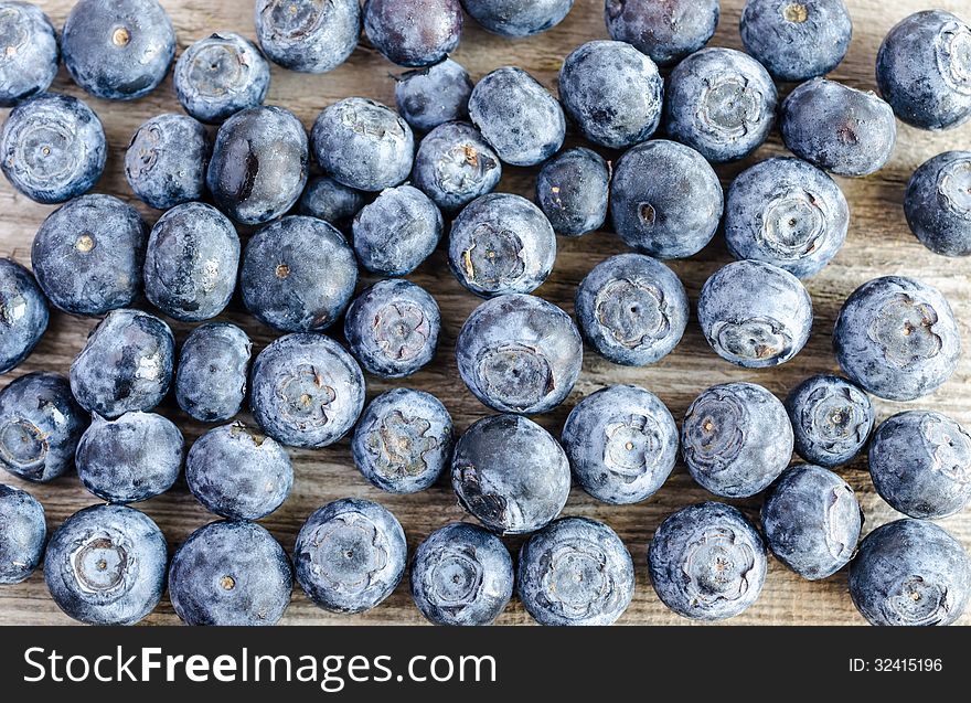 Closeup of ripe blueberries on wooden surface