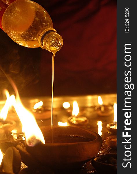 Hindu devotee oil lamp at festival. Hindu devotee oil lamp at festival.