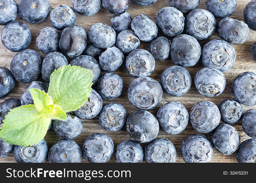 Closeup of ripe blueberries on wooden surface