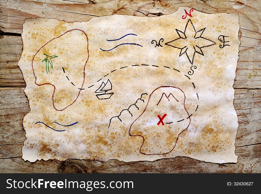 Treasure map on aged paper and wooden background. Treasure map on aged paper and wooden background