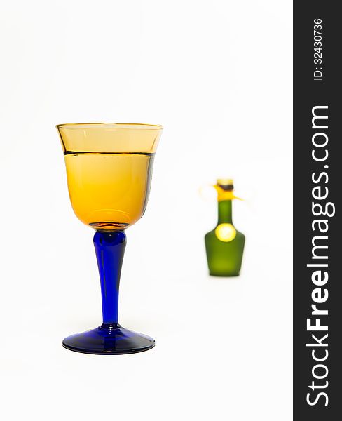 Zoom in whisky glass with blur green whisky bottle