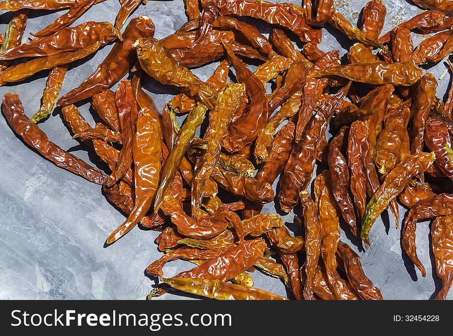 Dried red chili peppers background on plate. Dried red chili peppers background on plate