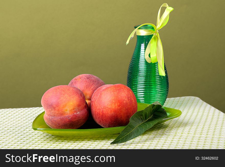 Peaches on a triangular plate and vase