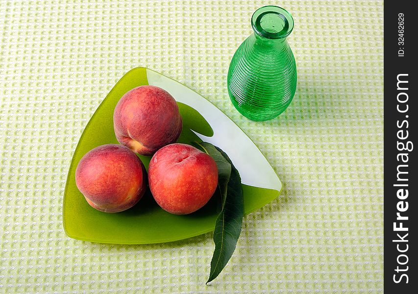 Peaches on a triangular plate and vase