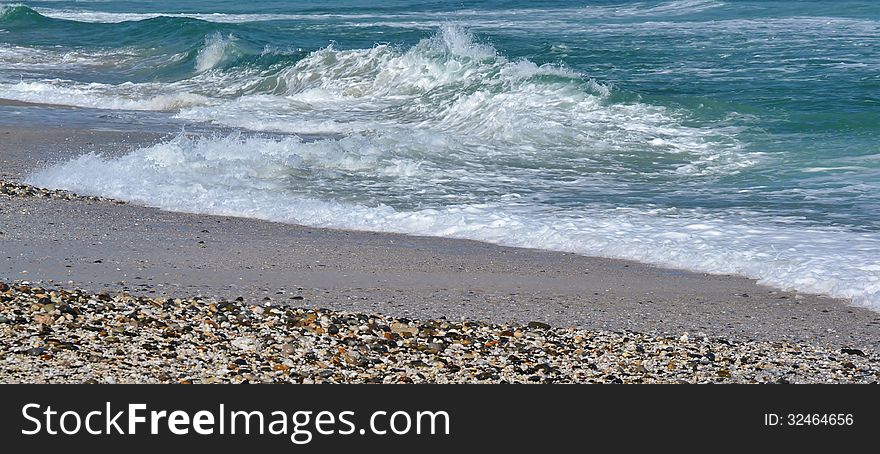 Seascape with pebbles on a beach and atlantic waves. Seascape with pebbles on a beach and atlantic waves