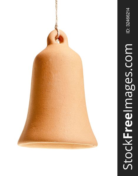 Handmade clay bell hanging from a rope on a white background