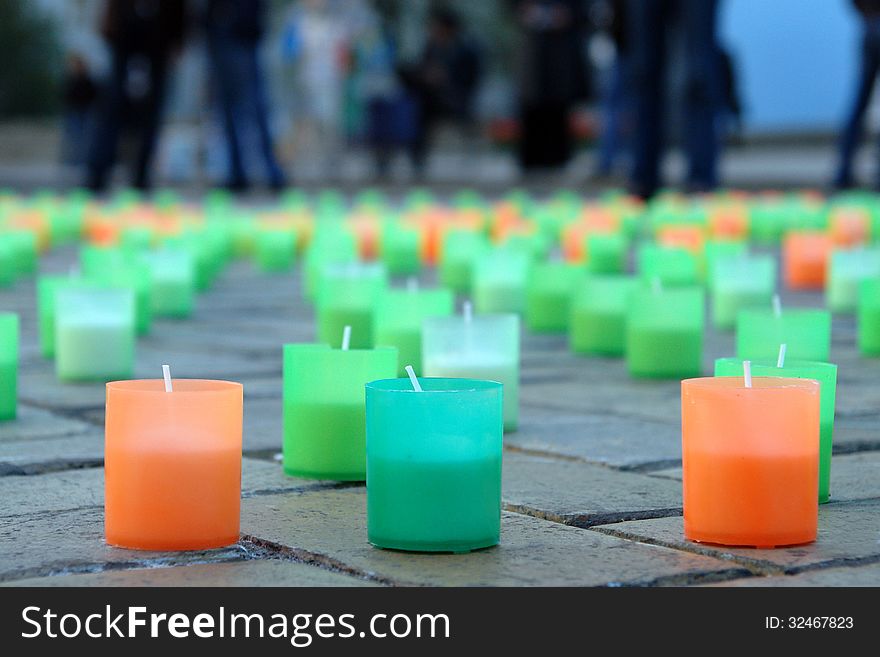 Colored candles on the pavement