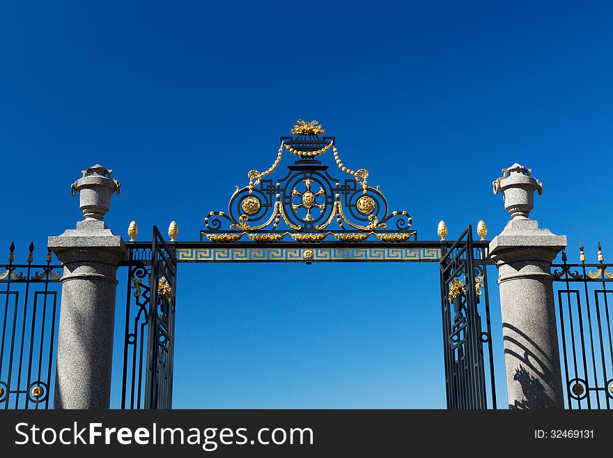 The gate and fence on a blue sky background. Summer Garden, St. Petersburg, Russia