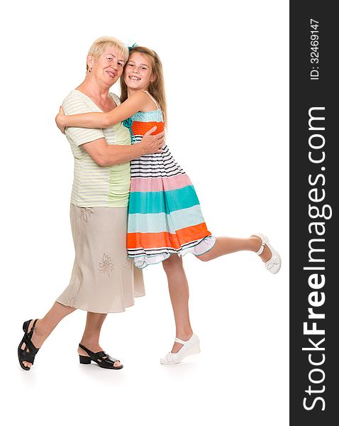 Grandmother with her granddaughter in the studio on a white isolate