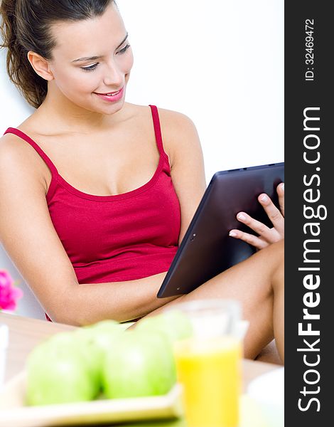 Pretty woman with tablet at home