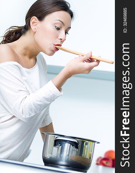 Beautiful woman cooking at the kitchen