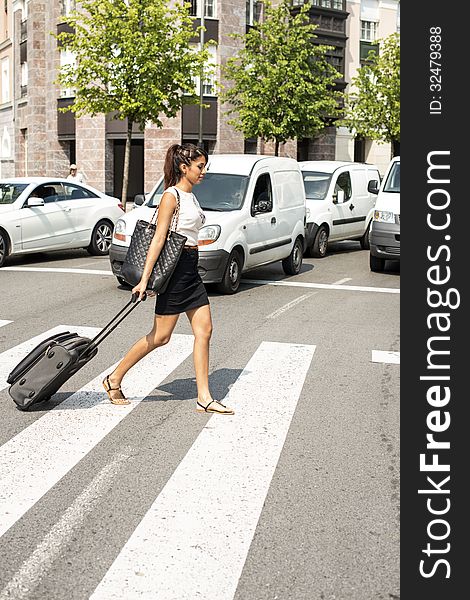 Business Woman Crossing The Street With Luggage.