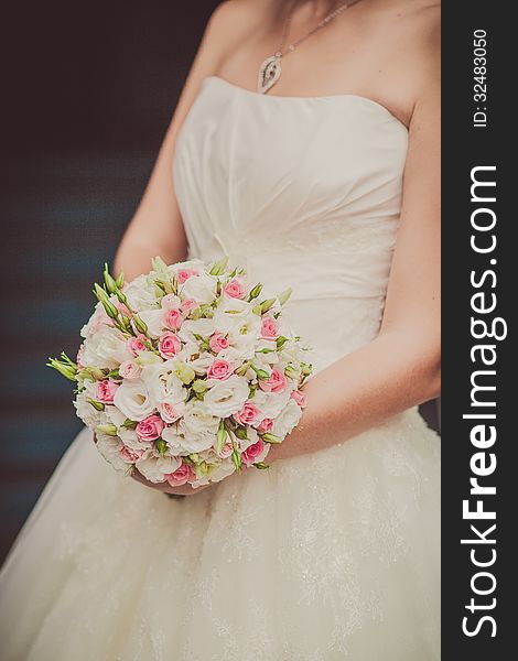 Bridal bouquet of flowers in hands of the bride